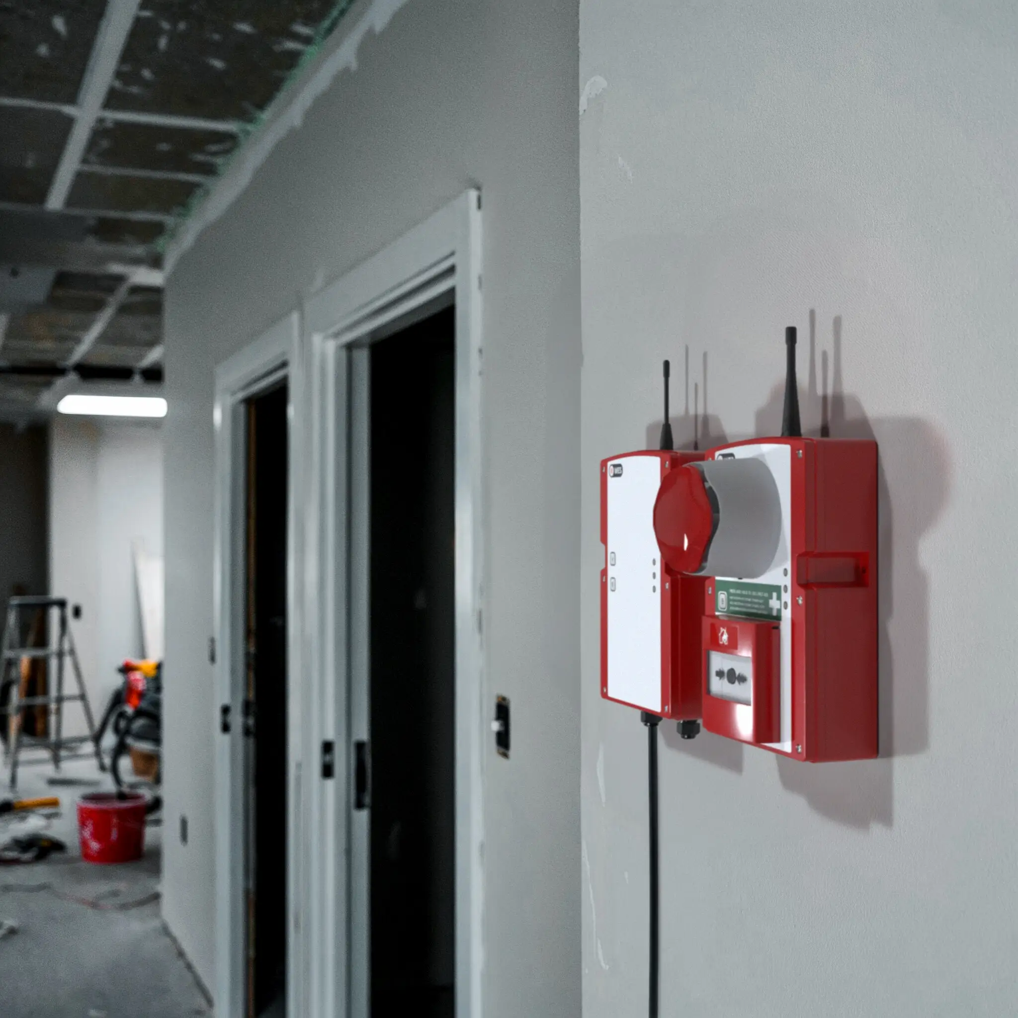 WES3 call point mounted on wall of building under renovation.