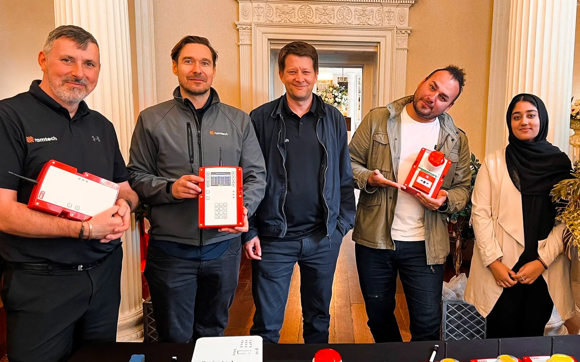 Ramtech People & Culture team holding WES wireless safety devices