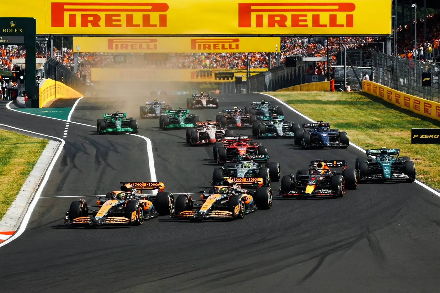 F1 cars racing on track at the Hungaroring where a temporary fire alarm system was deployed for safety.