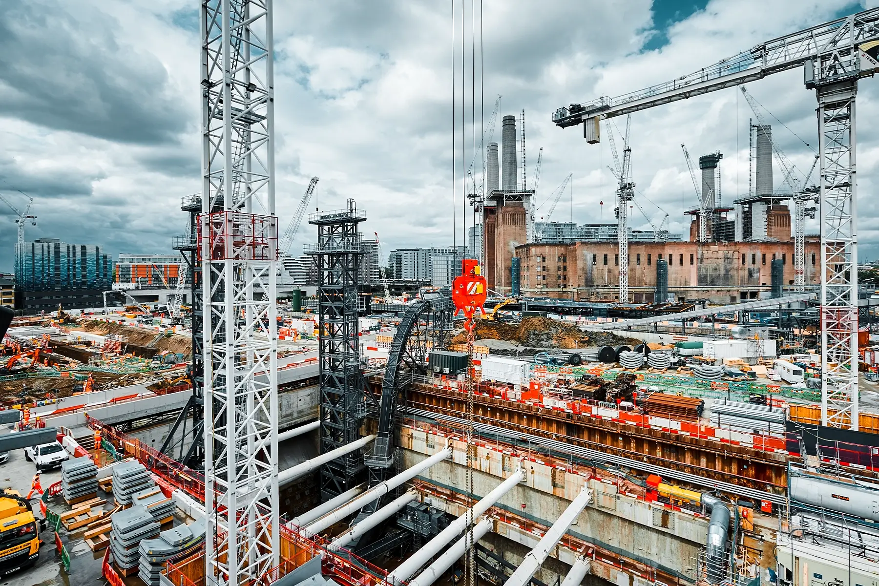 Large-scale construction site with cranes and excavation near Battersea Power Station for the Northern Line Extension Fire Safety.
